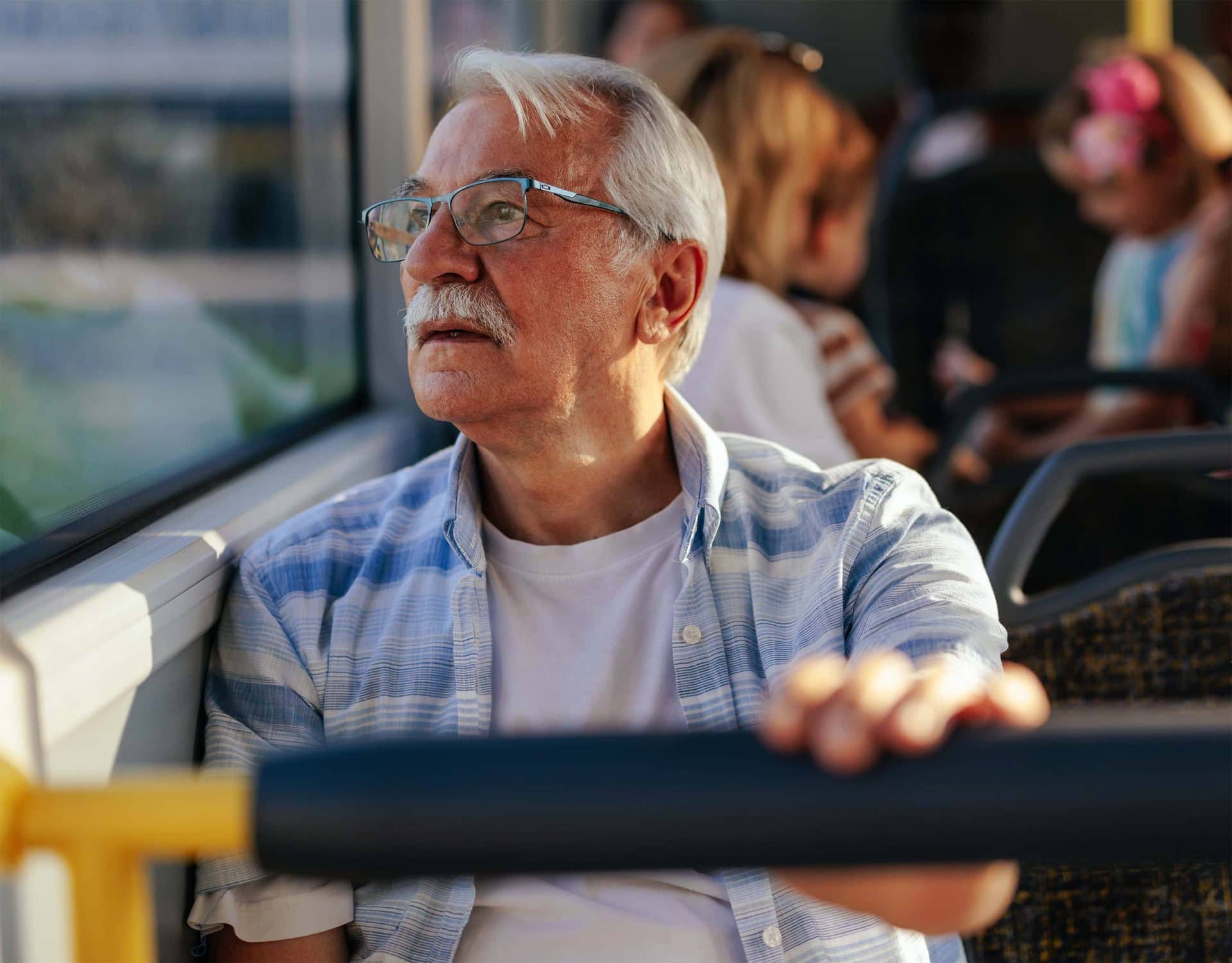 Older gentleman riding bus to work