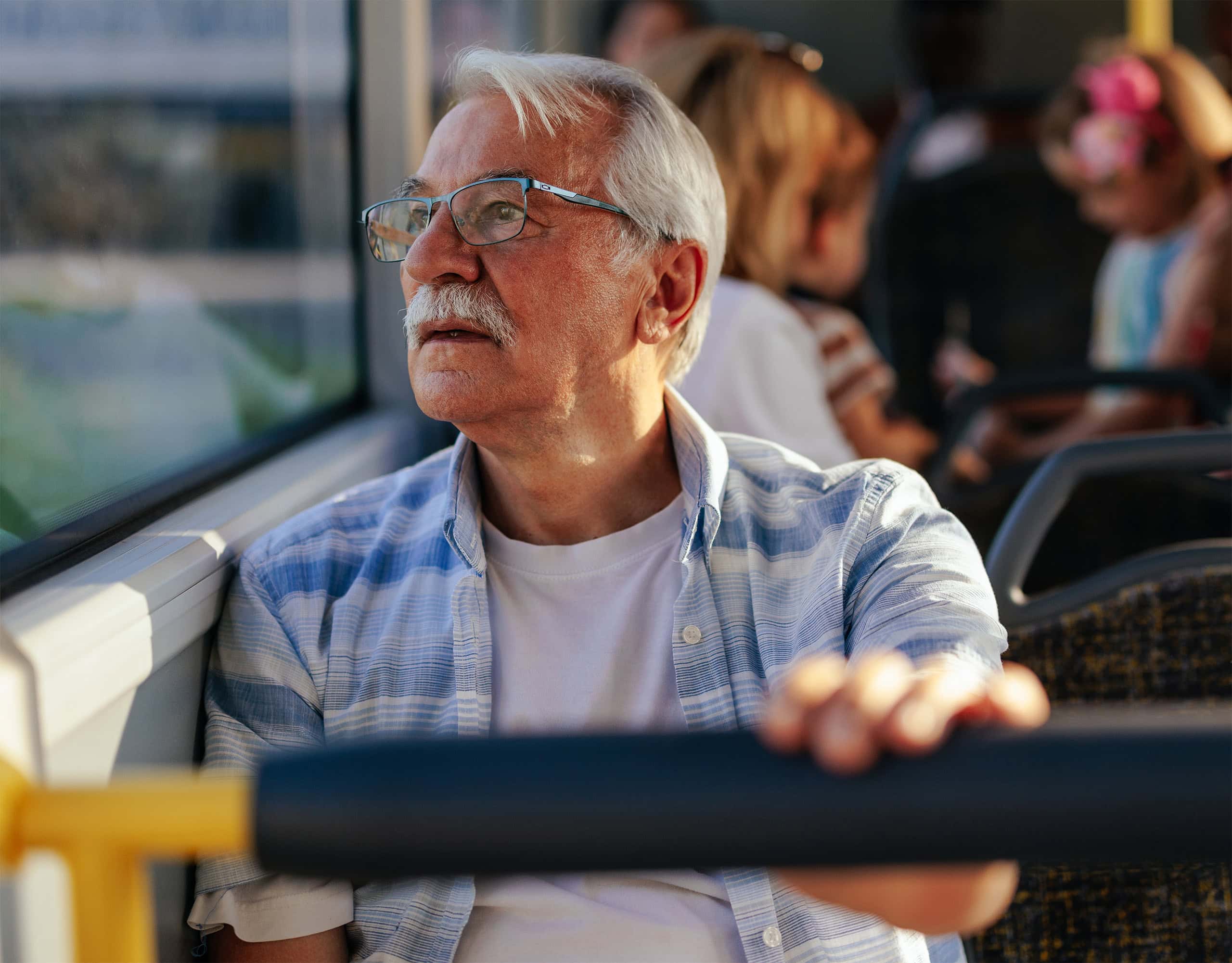 Older gentleman riding bus to work