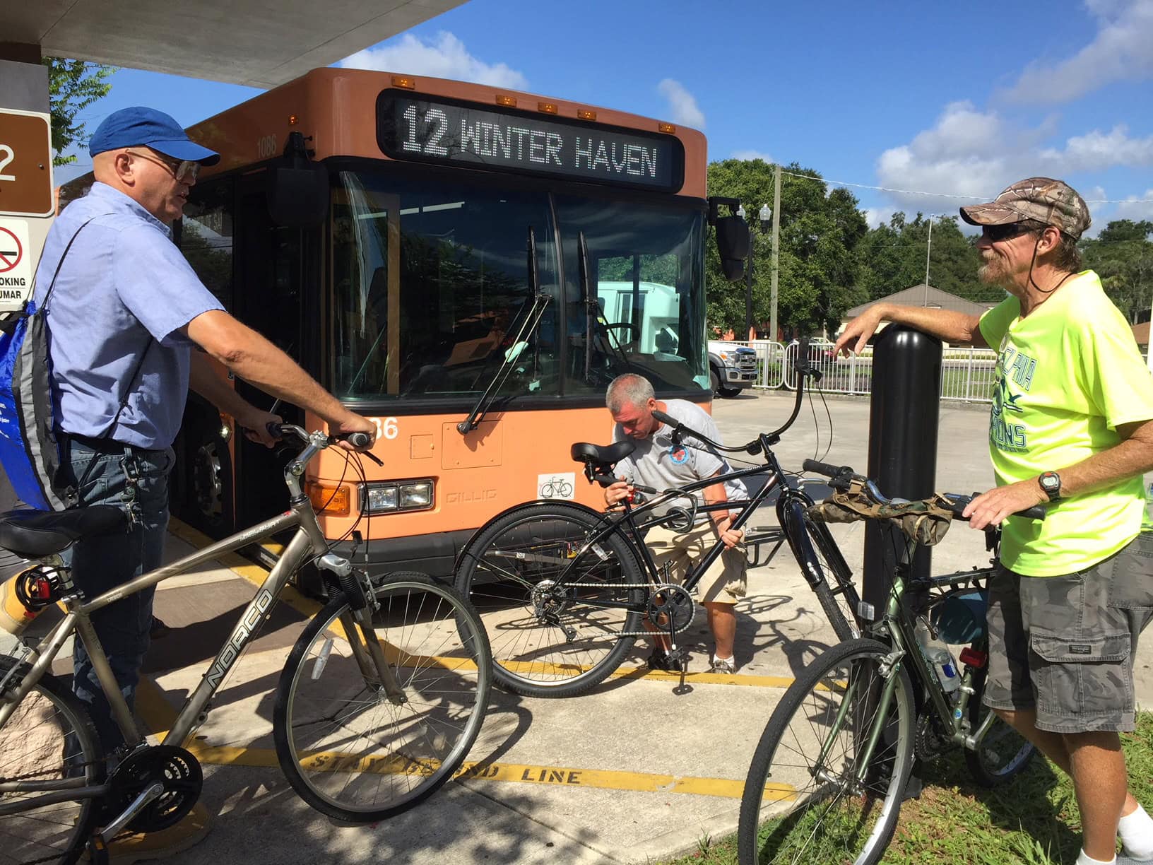 Passengers putting bikes onto bus
