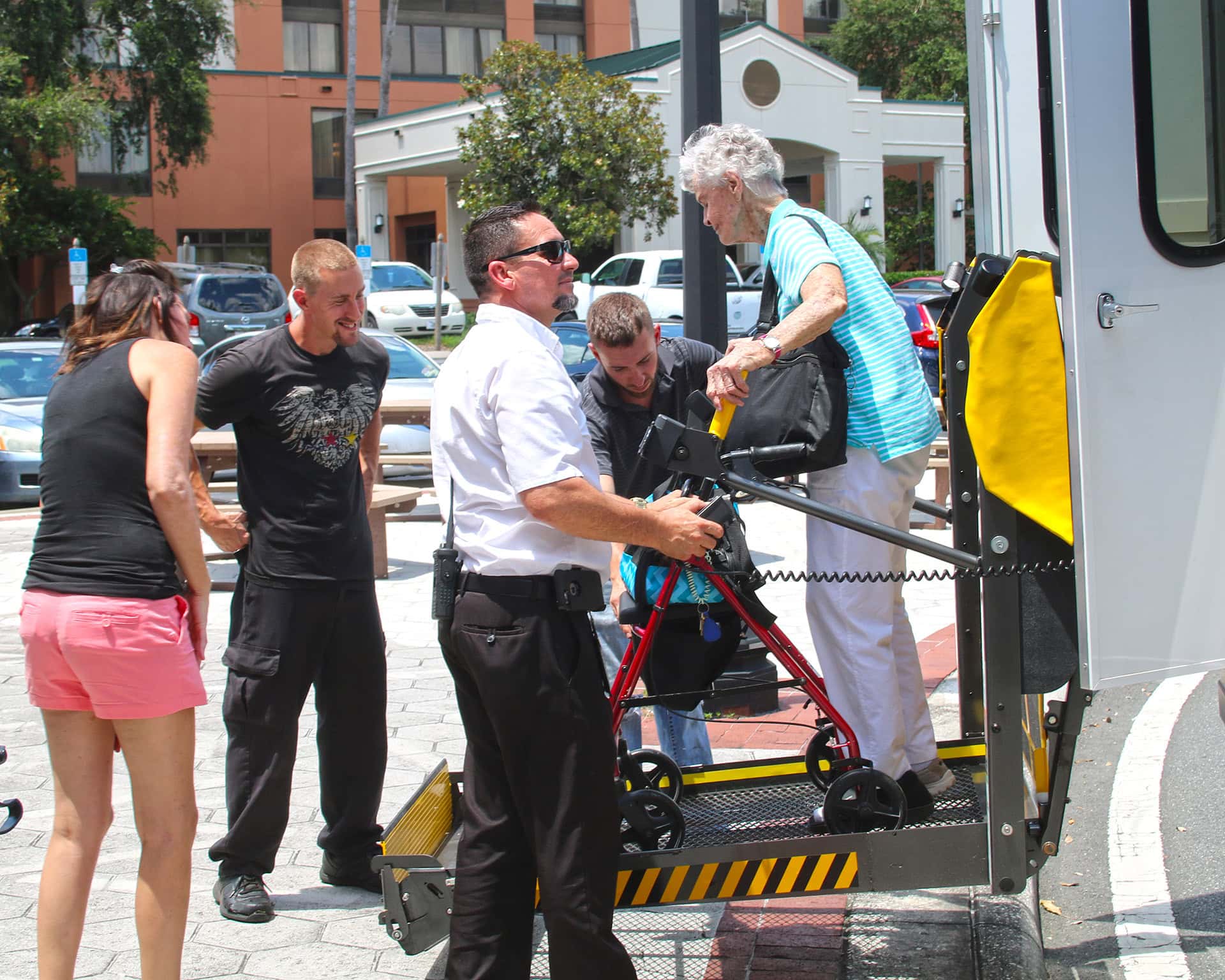 Person with disability being helped out of bus