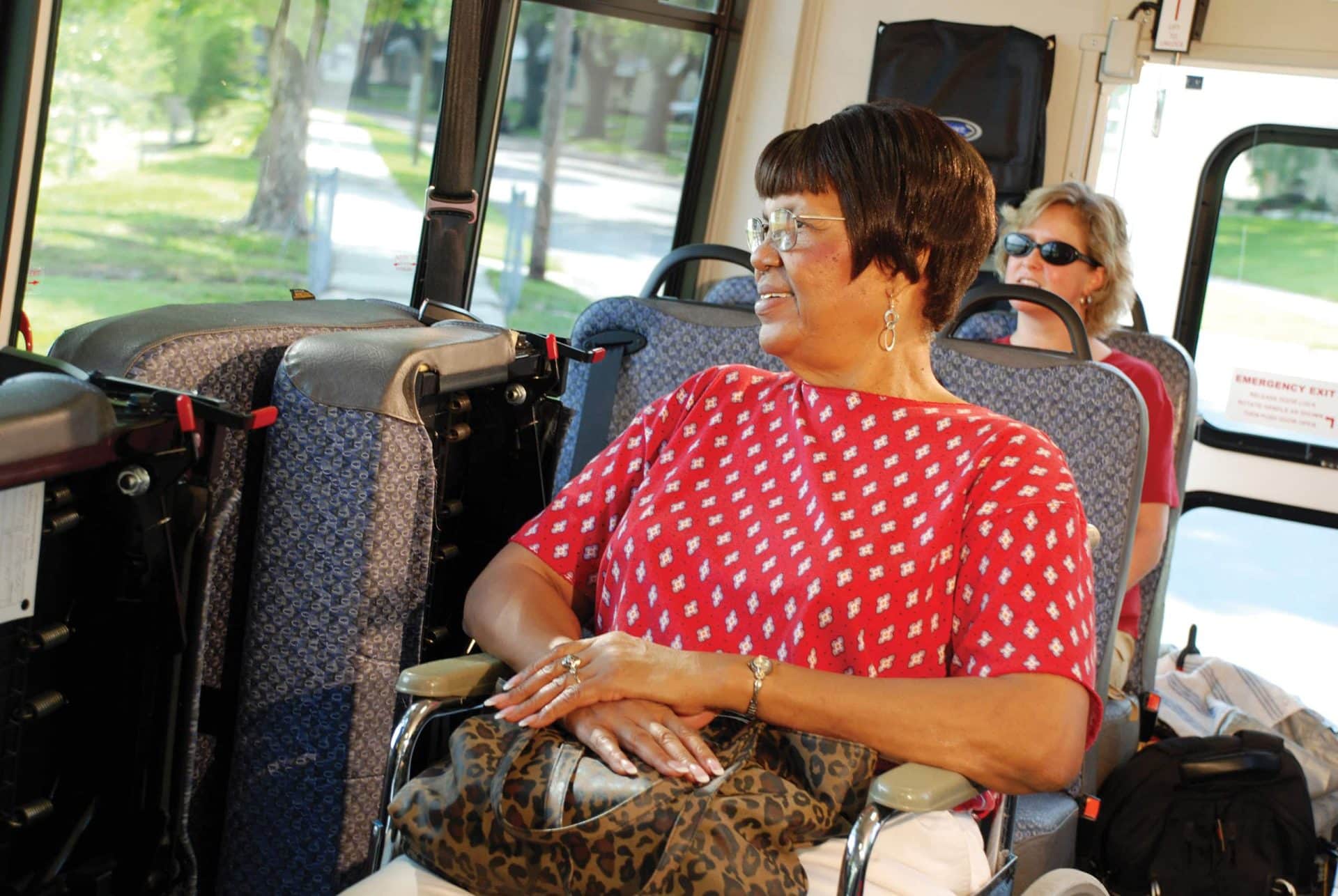 Woman in wheelchair using local bus.